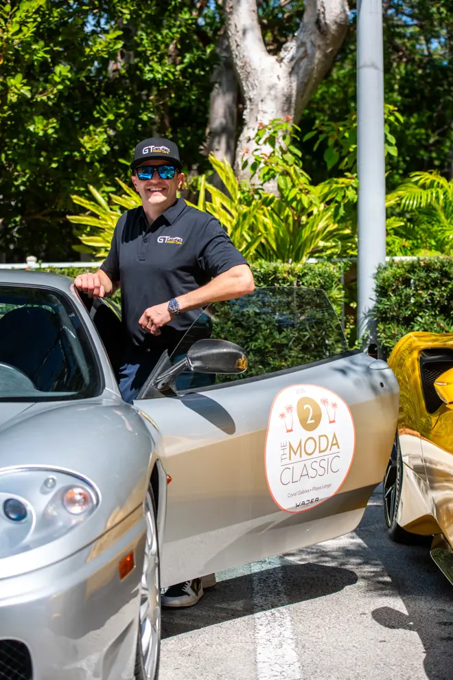 Round ModaMiami car decal placed on the driver’s door of a silver vehicle.
