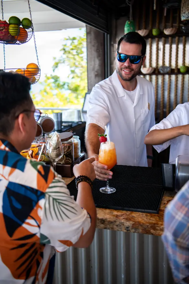 Orange cocktail served to a ModaMiami guest at an elegant outdoor bar.